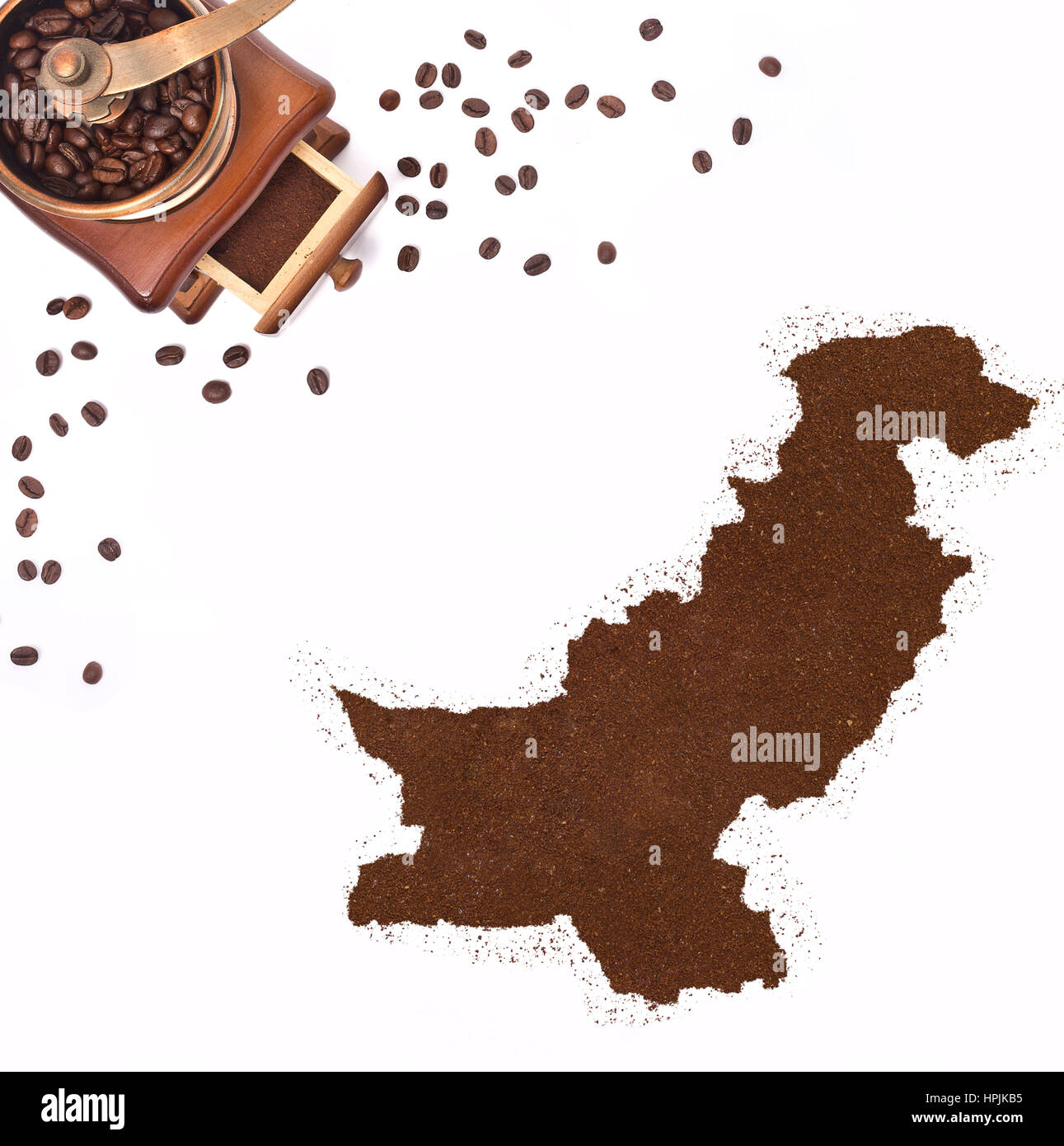 Coffee powder in the shape of Pakistan and a decorative coffee mill