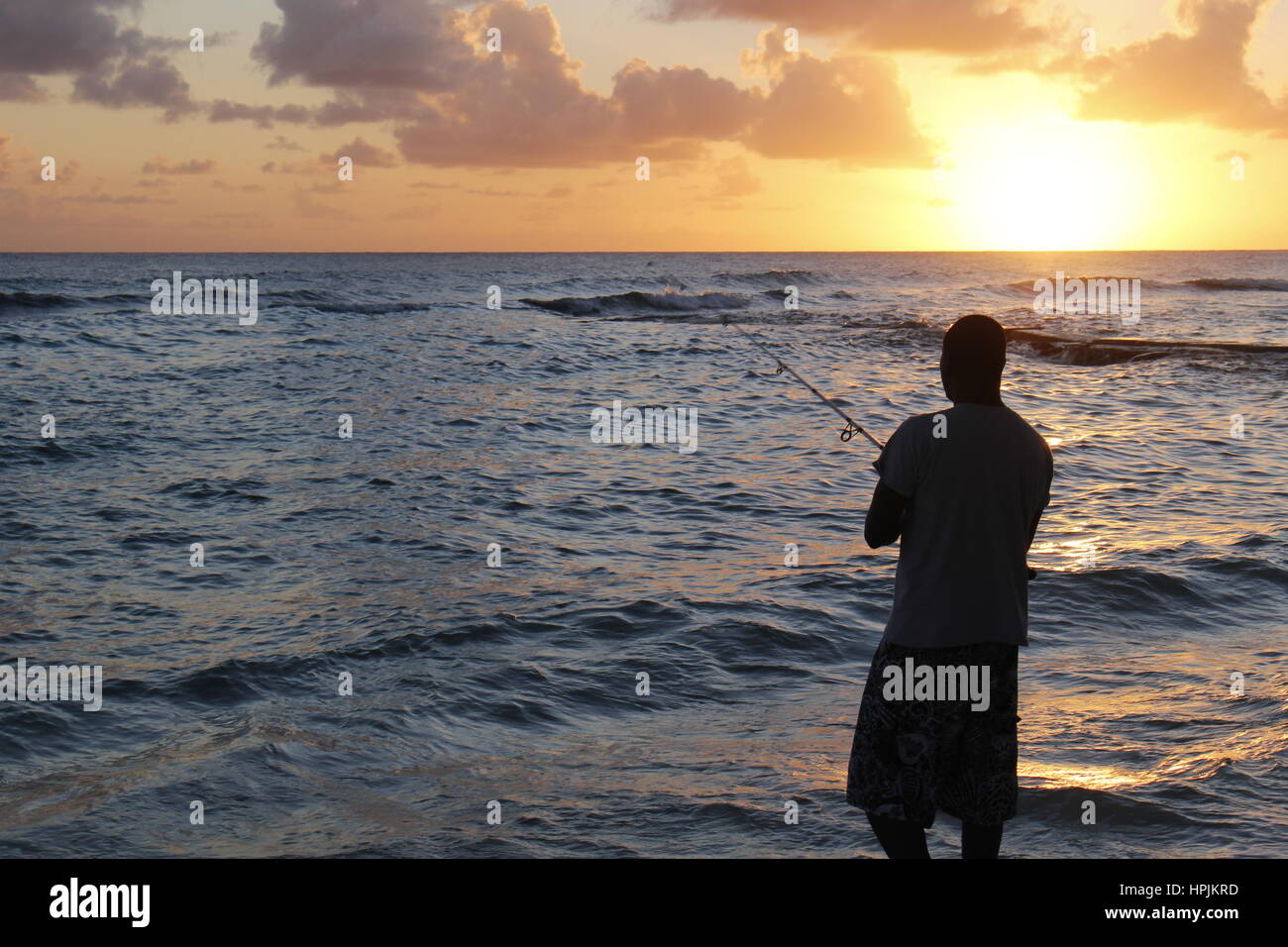 Fisherman fishing at sunset in the ocean,Hasting, Barbados, Caribbean Stock  Photo - Alamy