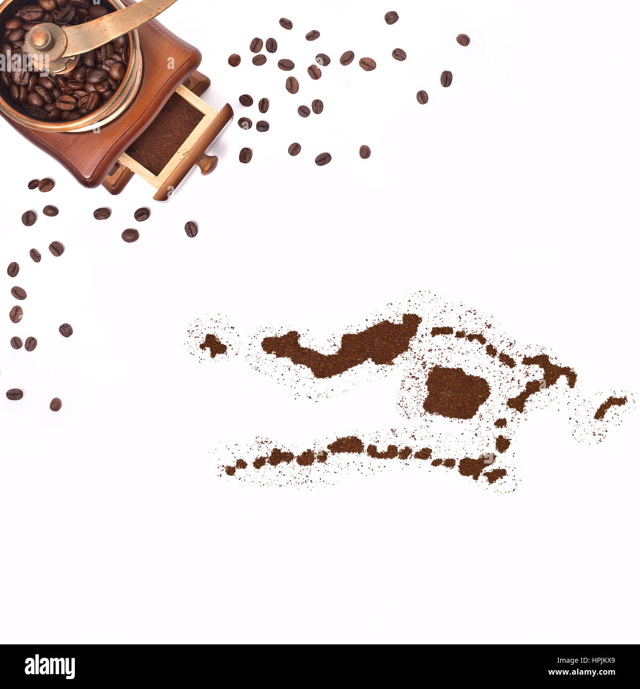 Coffee powder in the shape of Palmyra Atoll and a decorative coffee mill.(series) Stock Photo