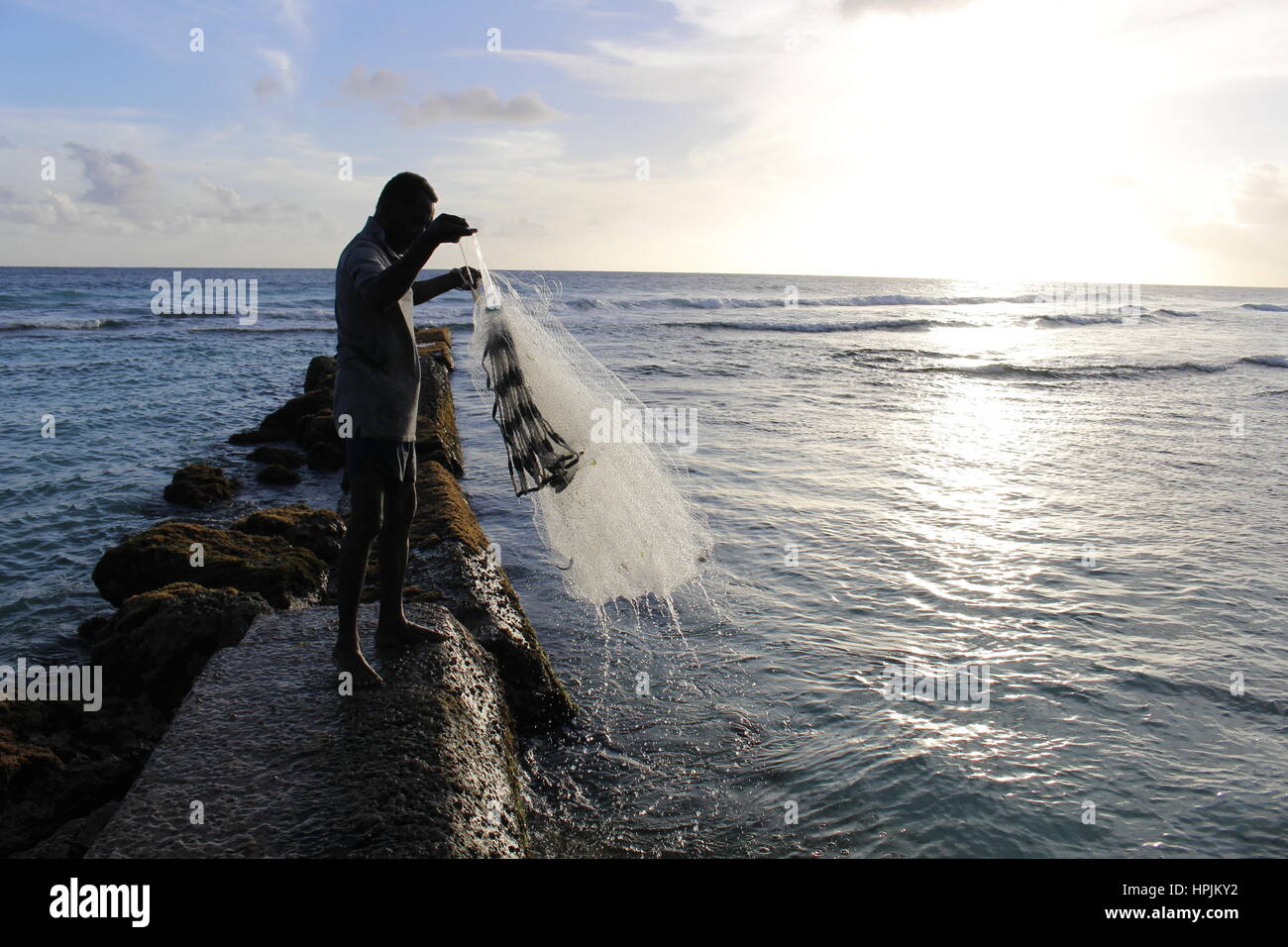 Fisherman casting his net in the sea, Hastings, Barbados