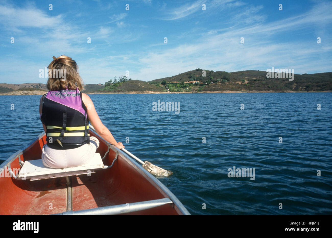 Woman paddling canoe on a lake Stock Photo