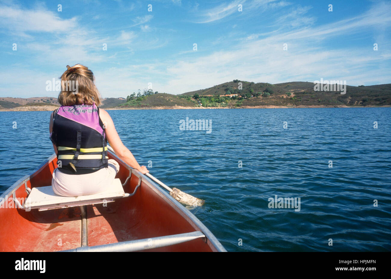 Woman paddling canoe on a lake Stock Photo Alamy