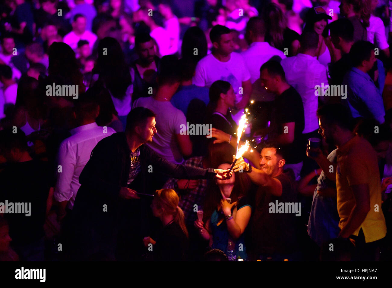 CLUJ NAPOCA, ROMANIA - JULY, 8, 2016: Man from the crowd holding burning torch in his hands at a live concert during Untold festival Stock Photo