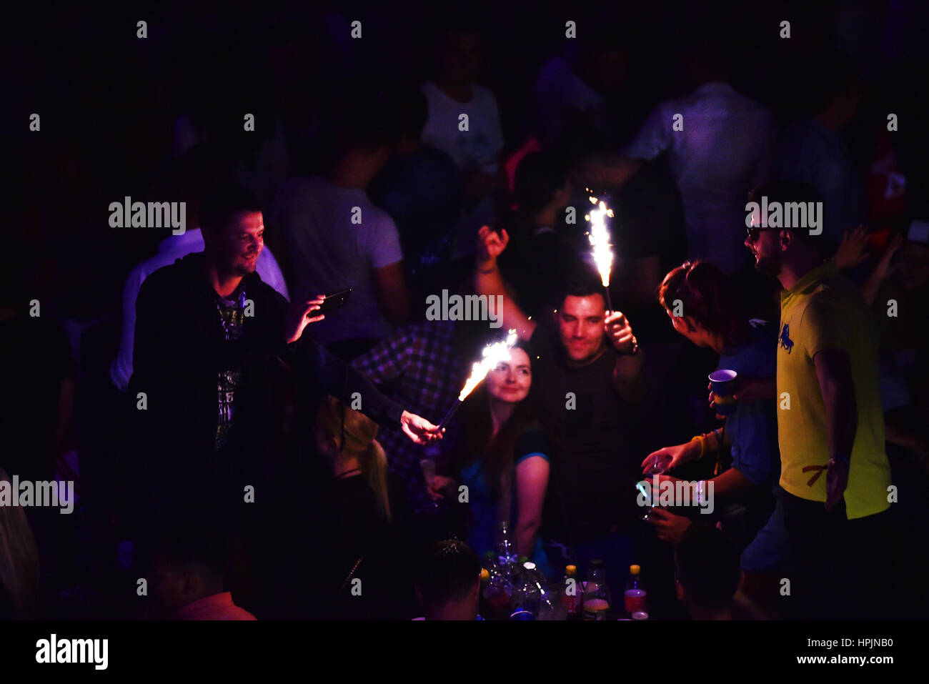 CLUJ NAPOCA, ROMANIA - JULY, 8, 2016: Man from the crowd holding burning torch in his hands at a live concert during Untold festival Stock Photo