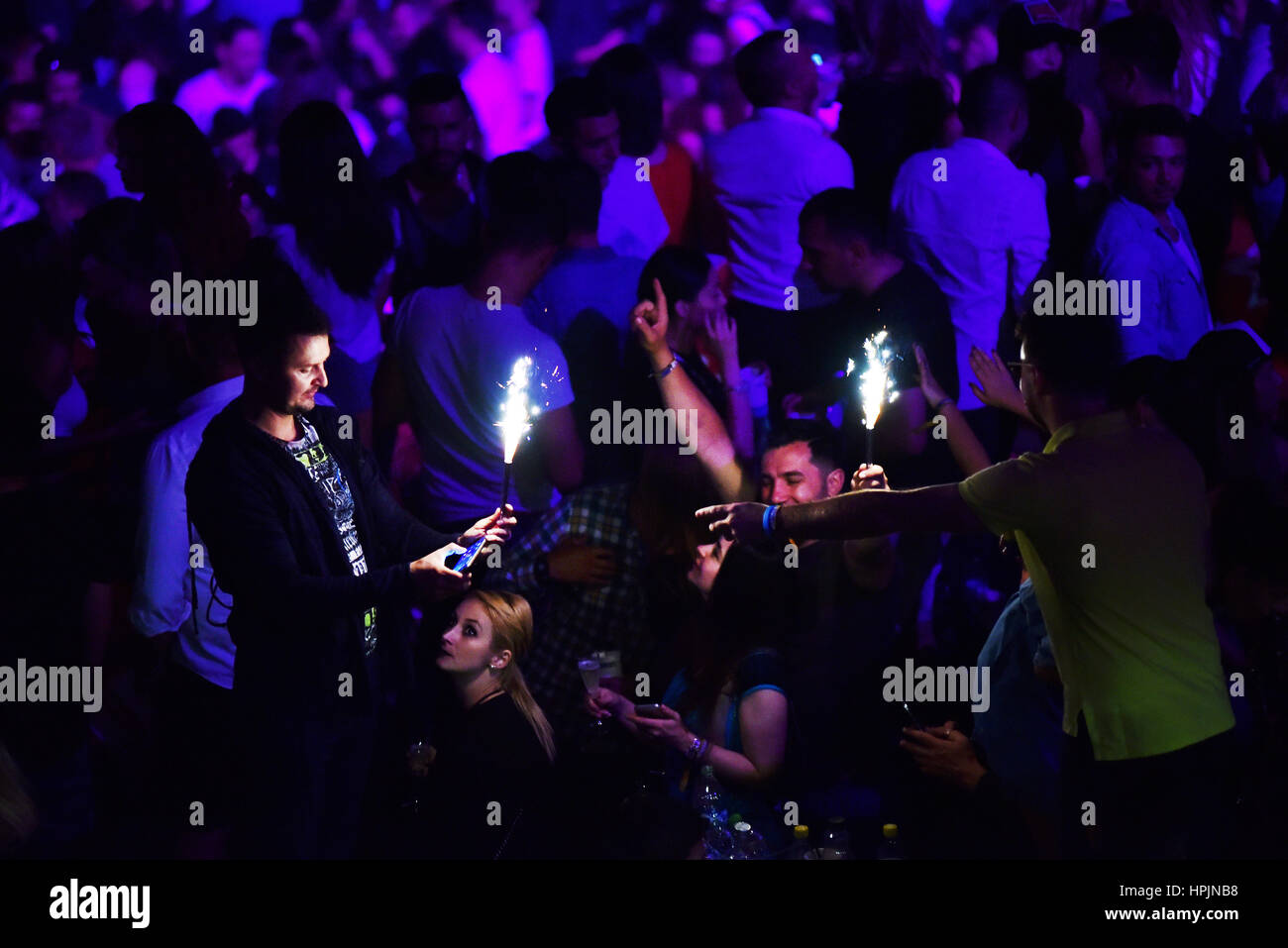 CLUJ NAPOCA, ROMANIA - JULY, 8, 2016: Man from the crowd holding burning torch in his hands at a live concert during Untold festival Stock Photo