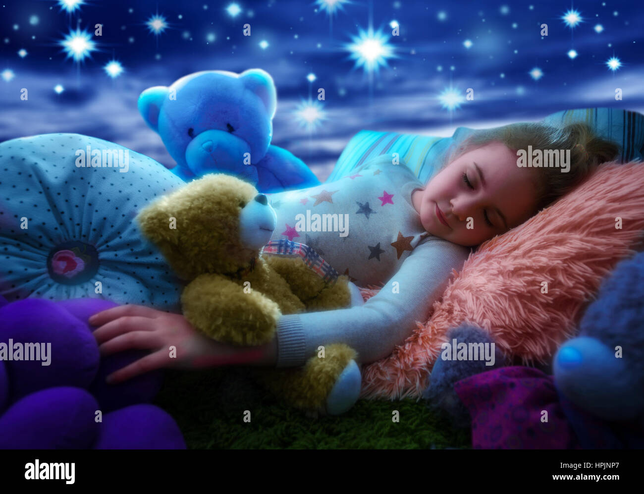 Little girl sleeping with teddy bear in bed, dreaming the starry sky at