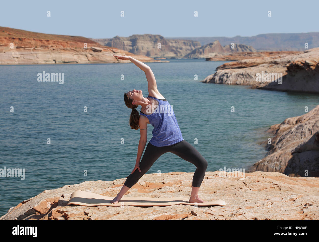 woman practicing yoga by lake Stock Photo - Alamy