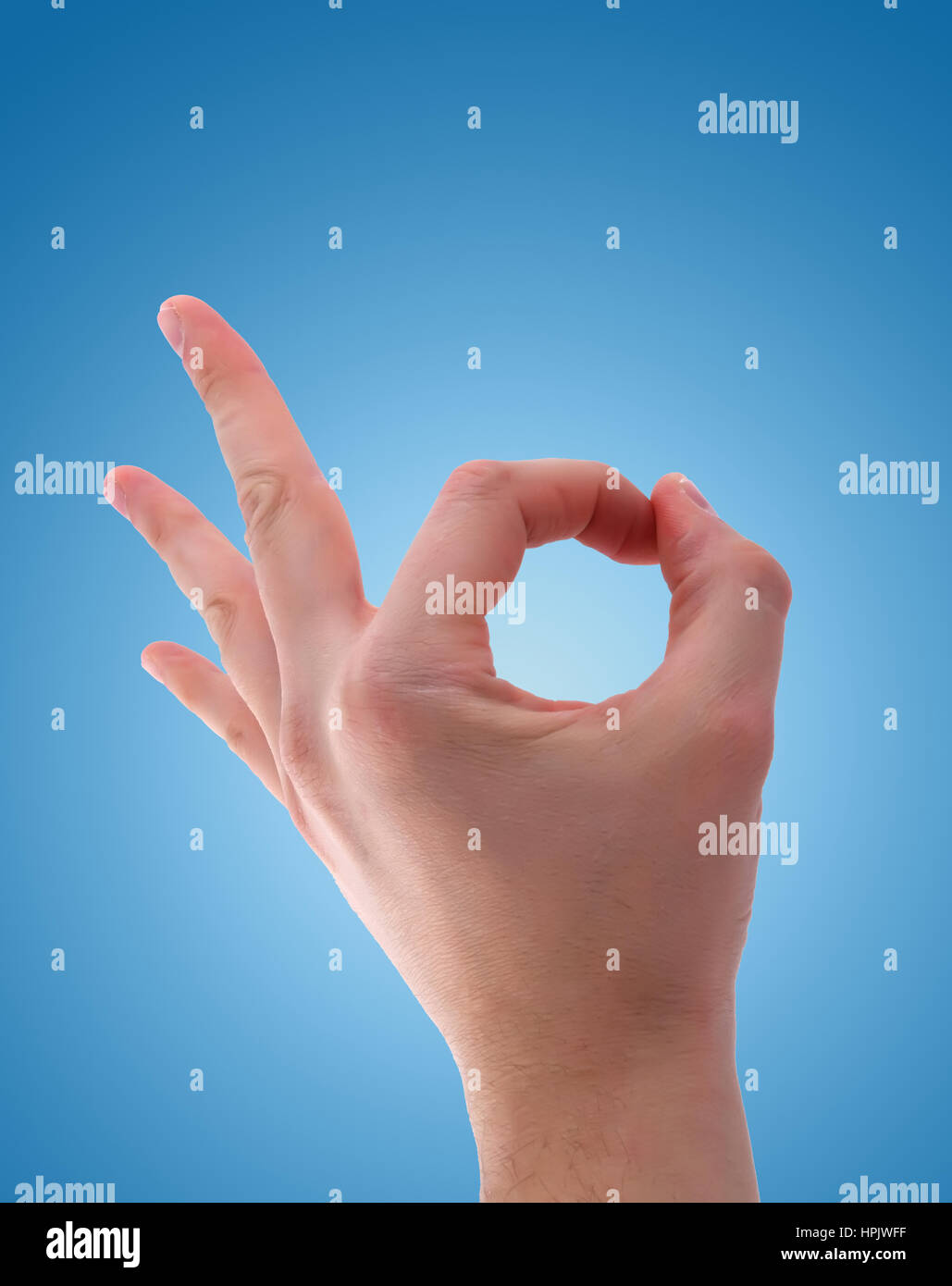 Ok hand sign on blue background Stock Photo Alamy