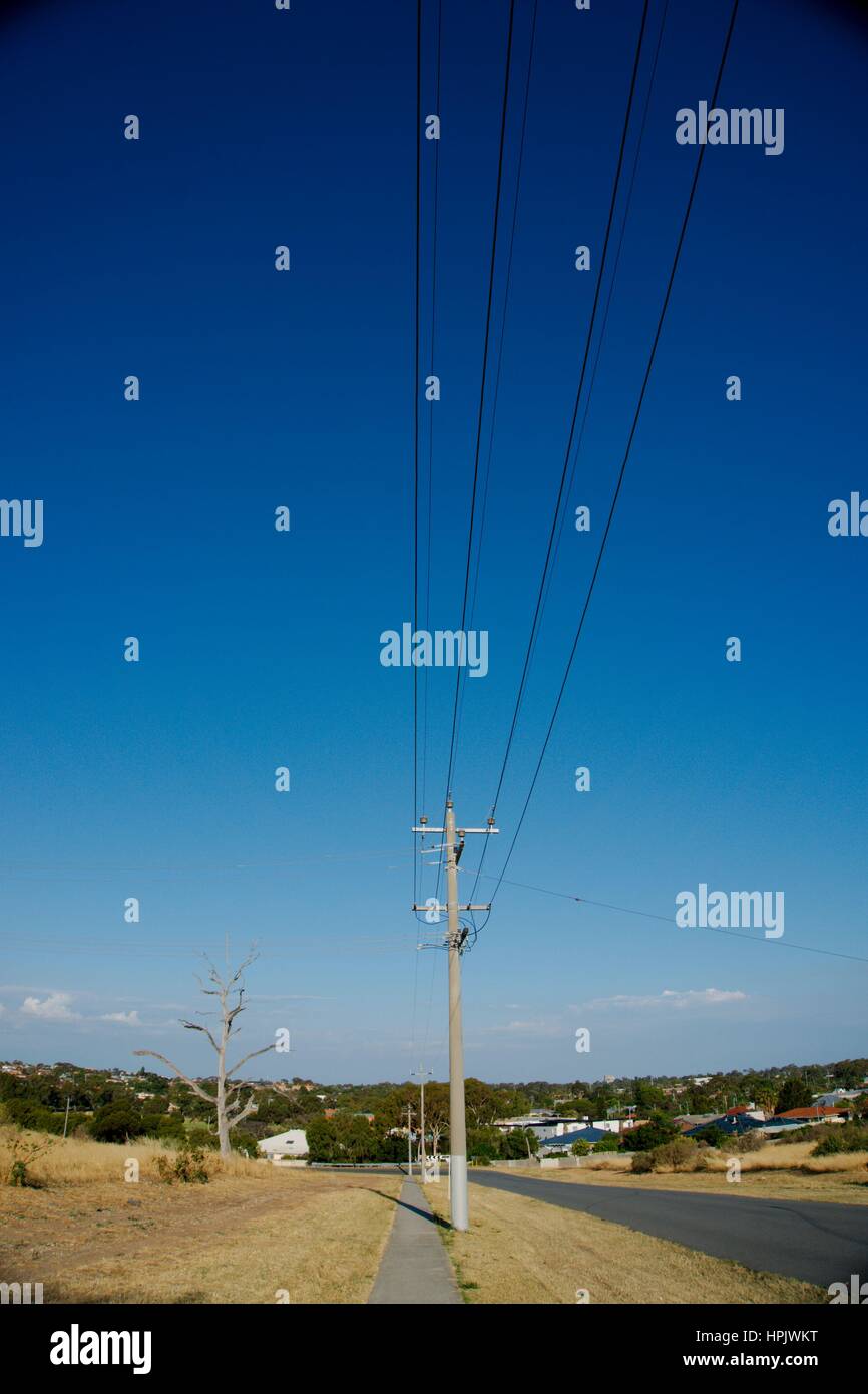 Electric column at the side of the road with dried grass Stock Photo