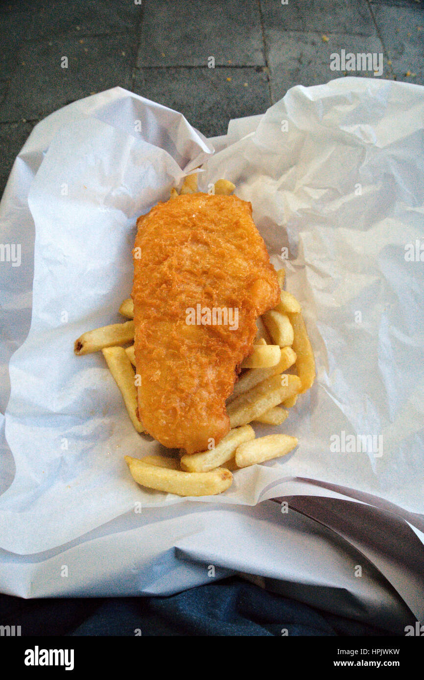 Fish and chips placed on layers of paper Stock Photo