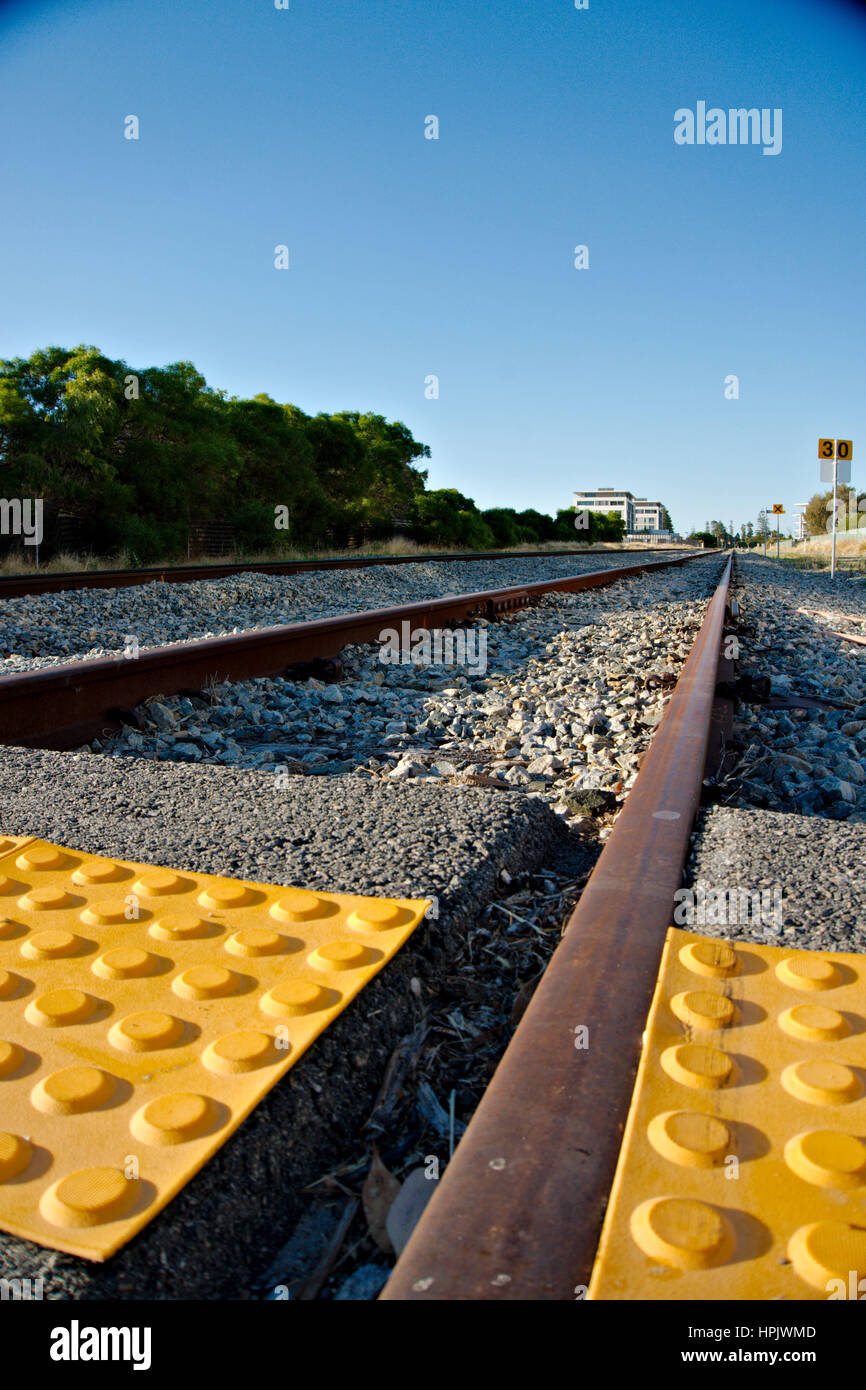 Low angle shot of a train track with tactile paving Stock Photo