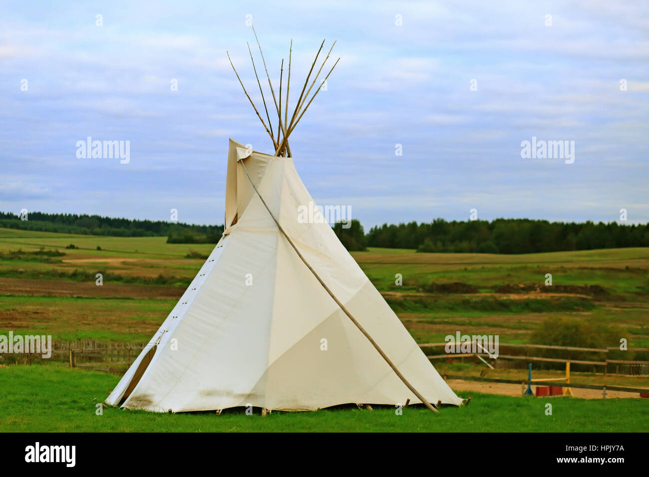 White wigwam on green field in the evening Stock Photo
