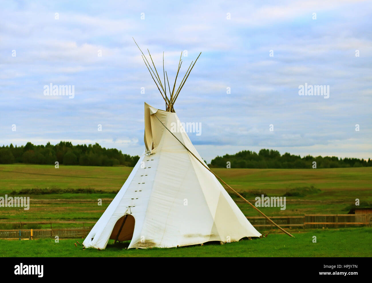 White wigwam on green field in the evening Stock Photo