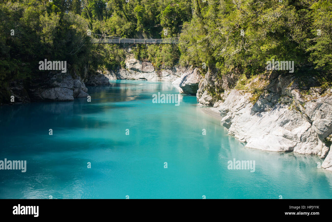 Hokitika, West Coast, New Zealand. View over the turquoise waters of the Hokitika River to swing bridge spanning the Hokitika Gorge. Stock Photo