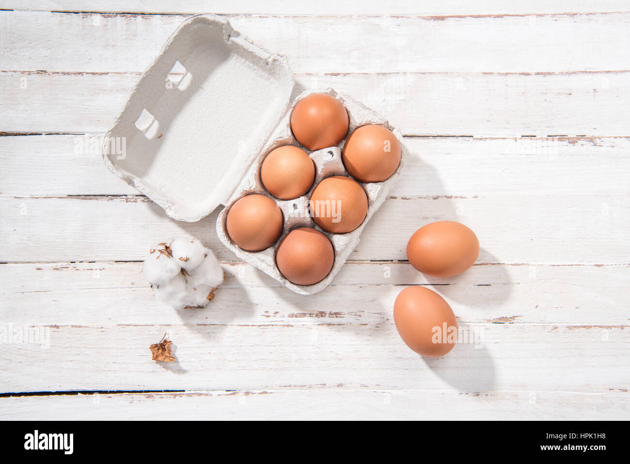 Top view of raw chicken eggs in egg box on white wooden table Stock ...