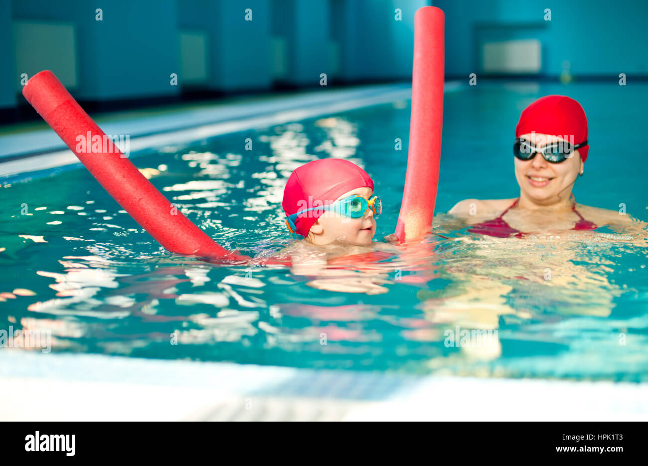 Little girl learning to swim with pool noodle Stock Photo Alamy