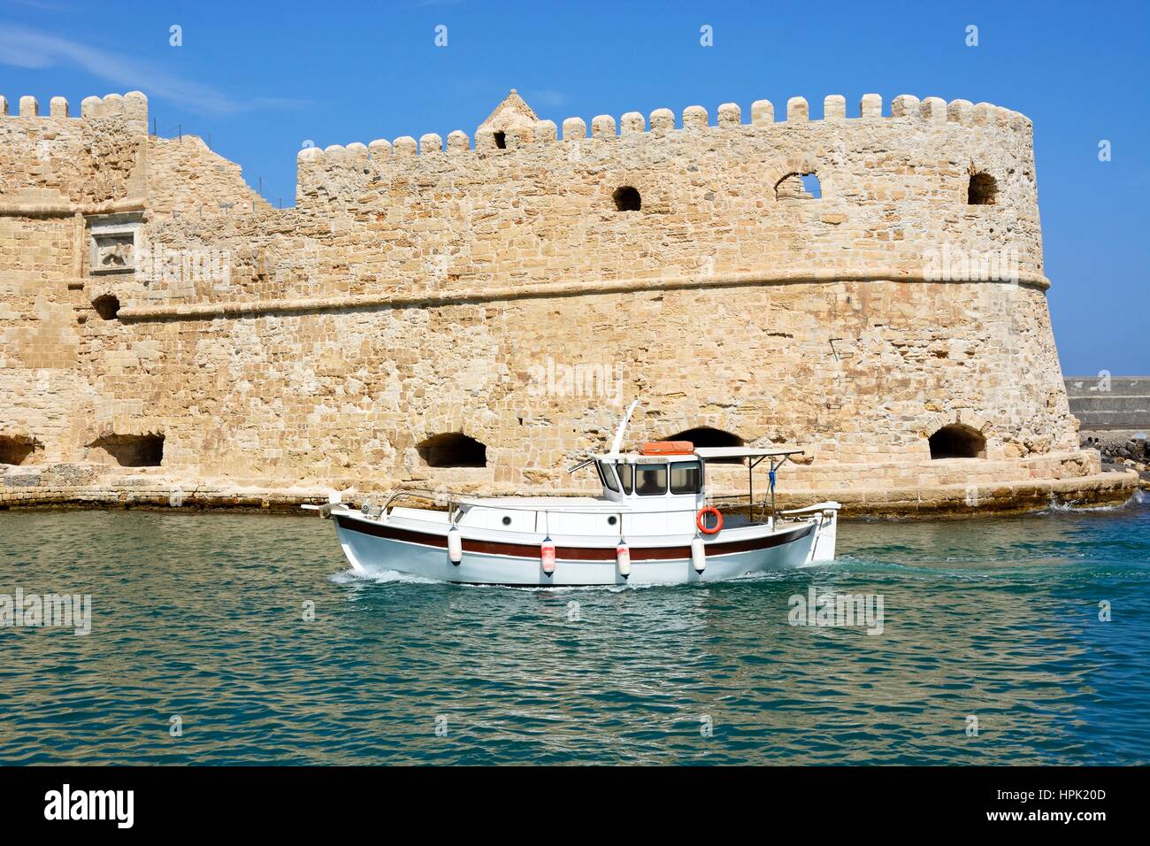 View of Koules castle with a boat in the foreground, Heraklion, Crete, Greece, Europe. Stock Photo