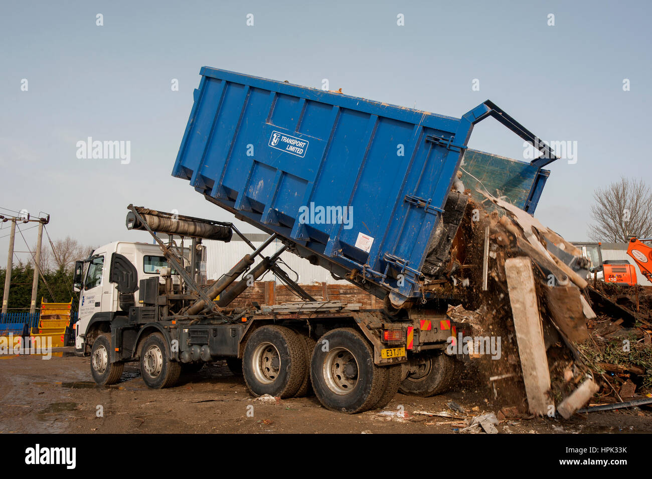 Commercial skip lorry with large waste dumpster Stock Photo