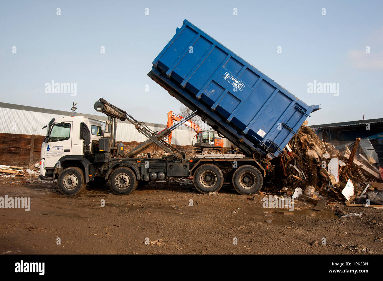 Commercial skip lorry emptying a large waste skip Stock Photo