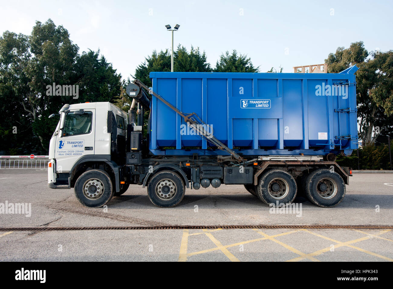 Commercial skip lorry with large waste dumpster Stock Photo