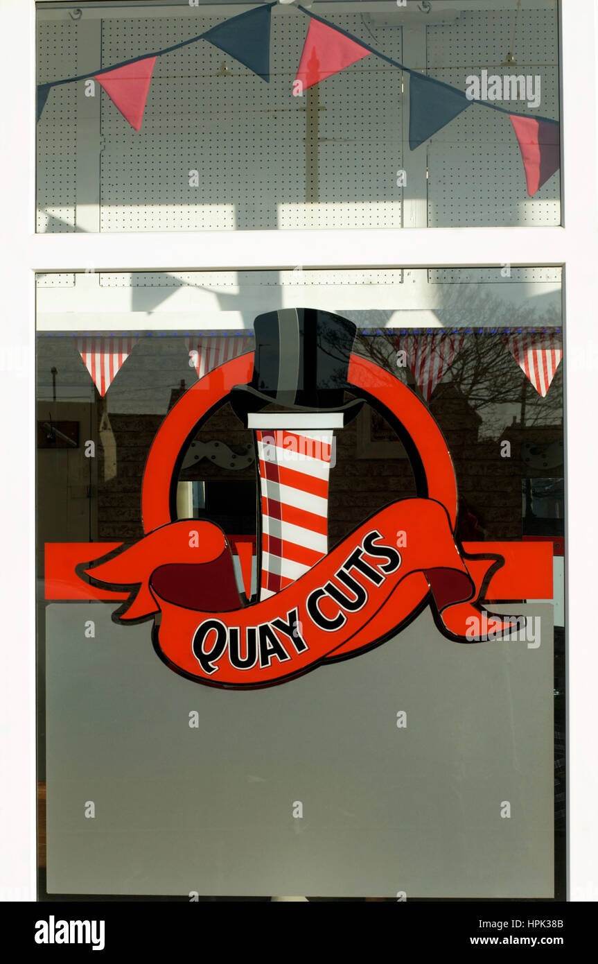 Barber shop with barbers pole design on front window Stock Photo