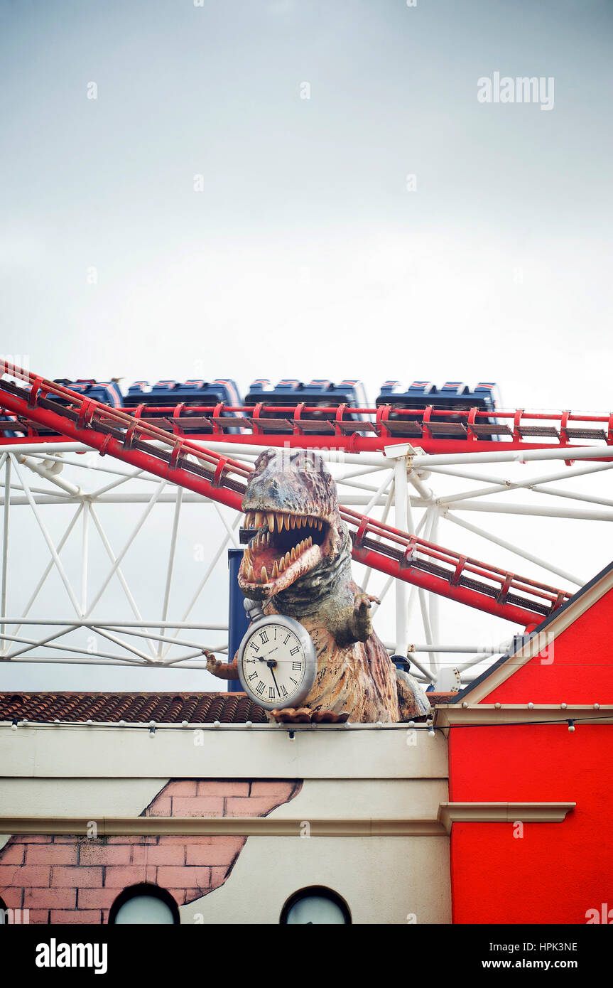 Dinosaur and clock with roller coaster in background Stock Photo