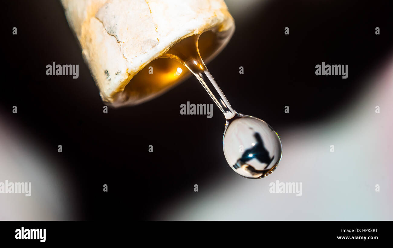 water drop falling down from the pipe line very close up macro shot glassy bubble look Stock Photo