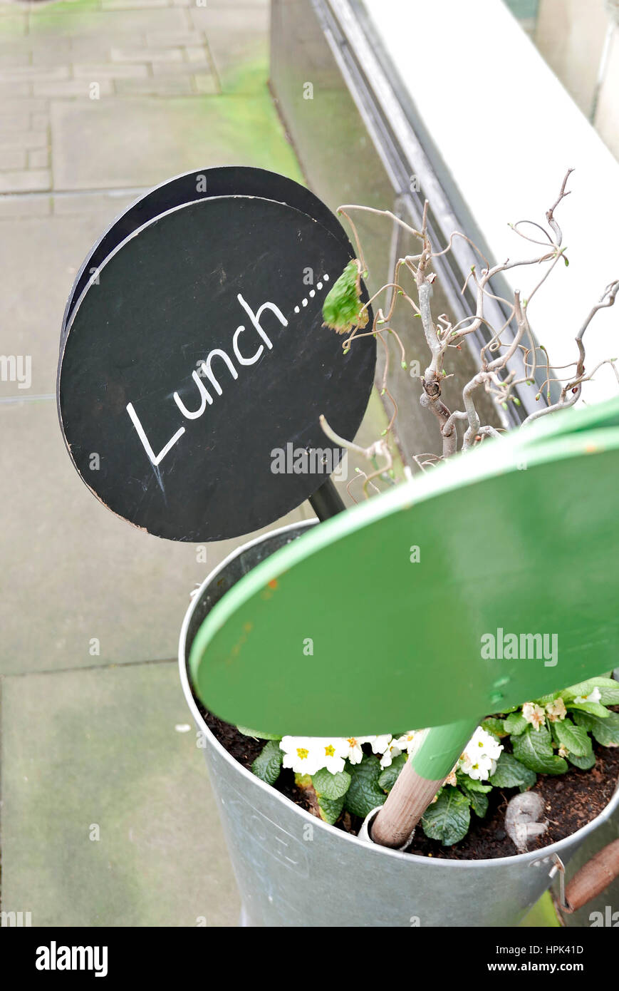 Round wooden signs outside shop inviting people to lunch Stock Photo