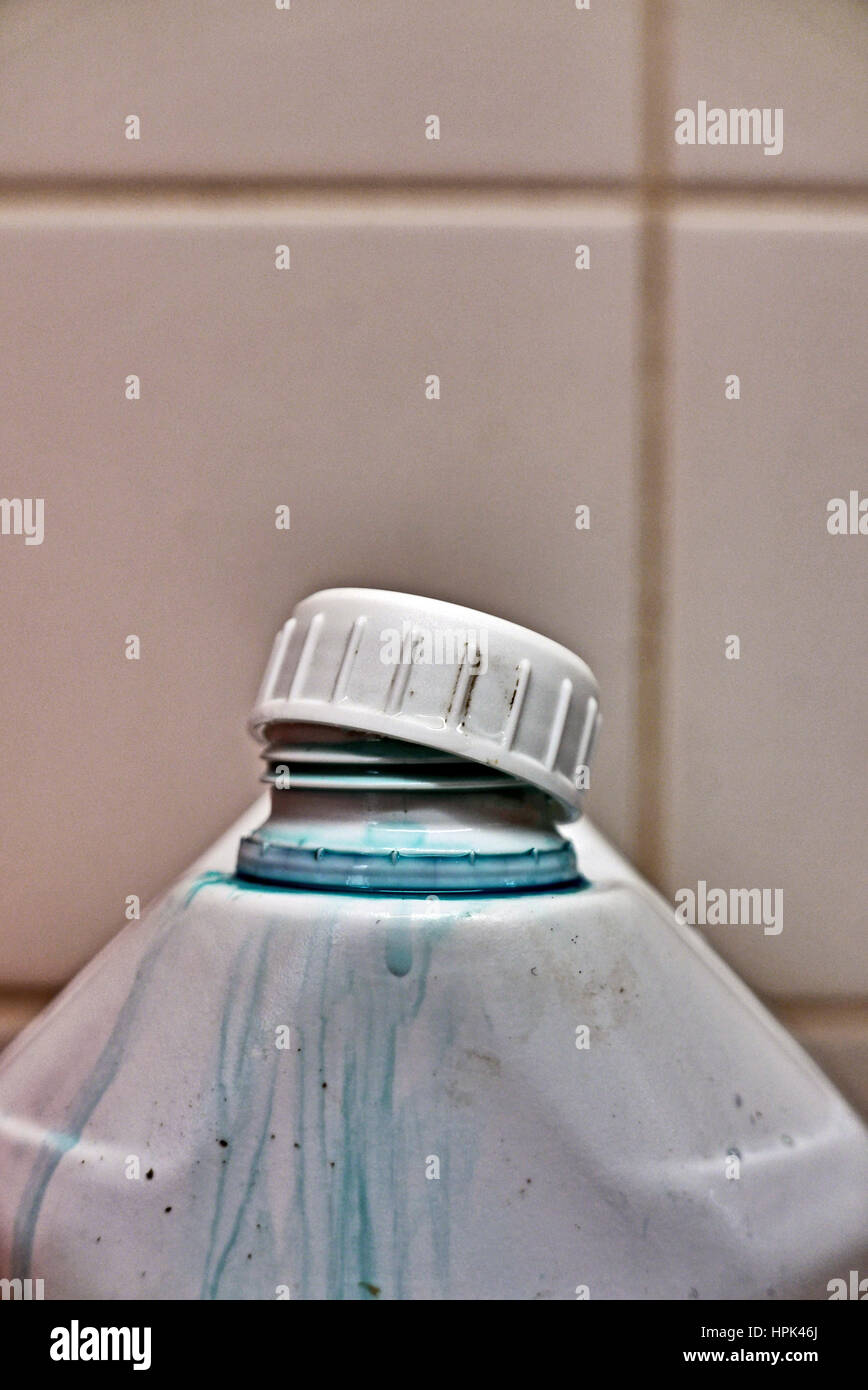 Chemical spillage from white plastic bottle with poorly fitting cap Stock Photo