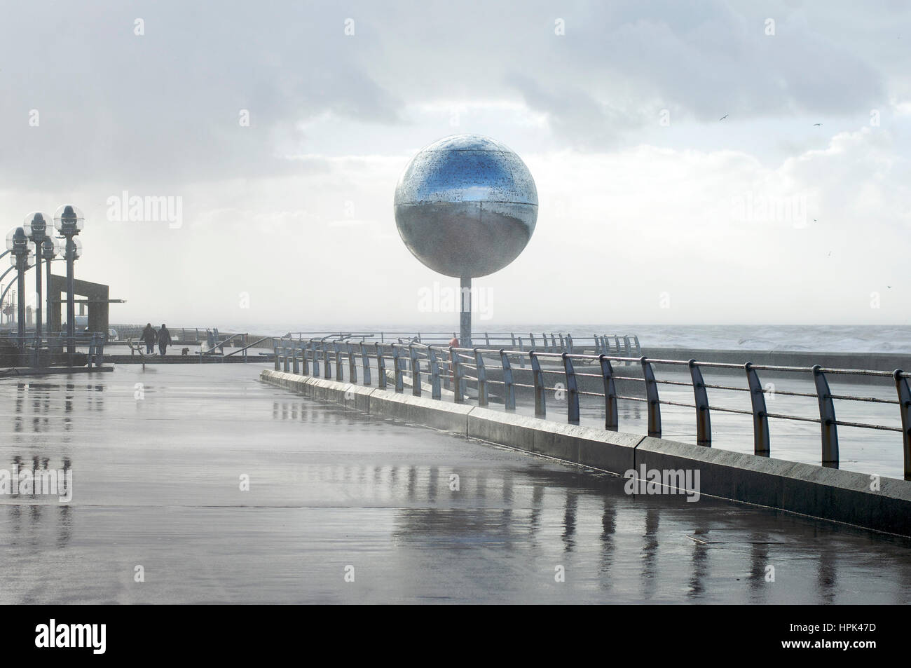 Winter storm blowing against the giant mirror ball on Blackpool seafront Stock Photo