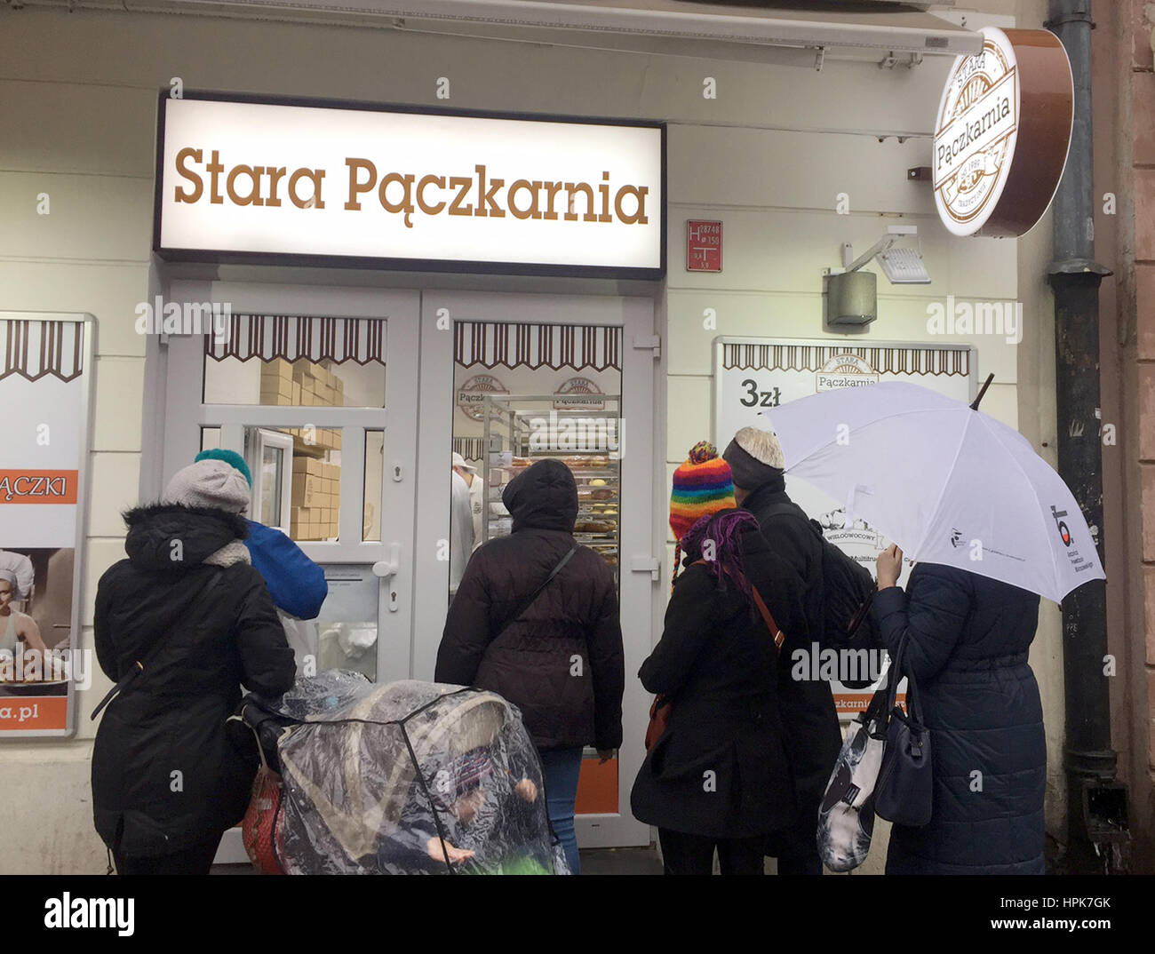 Warsaw, Ppland. 22nd Feb, 2017. Customers waiting in front of the Stara Paczkarnia (lt. Old Pancake Bakery) patisserie on Nowy Swiat in Warsaw, Ppland, 22 February 2017. Numerous Poles are waiting in front of the shop for sweets: with sweet and particularly greasy pastries they will celebrate the favorite holiday day of Polish sweets, the so-called 'Fat Thursday' (tlusty czwartek). Photo: Natalie Skrzypczak/epa Scanpix Sweden/dpa/Alamy Live News Stock Photo