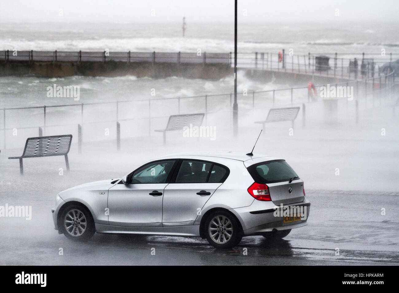 New Brighton, UK. Uk Weather.  23rd February, 2017 Storm winds intensify as motorists queue for a free car wash. Even as the tide recedes the winds intensify as Sorm Doris makes landfall.  The Marine Lake at New Brighton is whipped up to frenzy during the severe storm.  Credit MediaWorldImages/AlamyLiveNews. Stock Photo