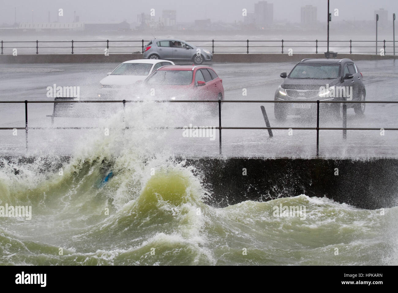 New Brighton, UK. Uk Weather.  Storm winds intensify as motorists queue for a free car wash. Even as the tide recedes the winds intensify as Storm Doris makes landfall.  The Green Marine Lake at New Brighton is whipped up to frenzy during the severe storm;  Warnings exist that the water could be unsafe and harmful to health.  Credit MediaWorldImages/AlamyLiveNews. Stock Photo