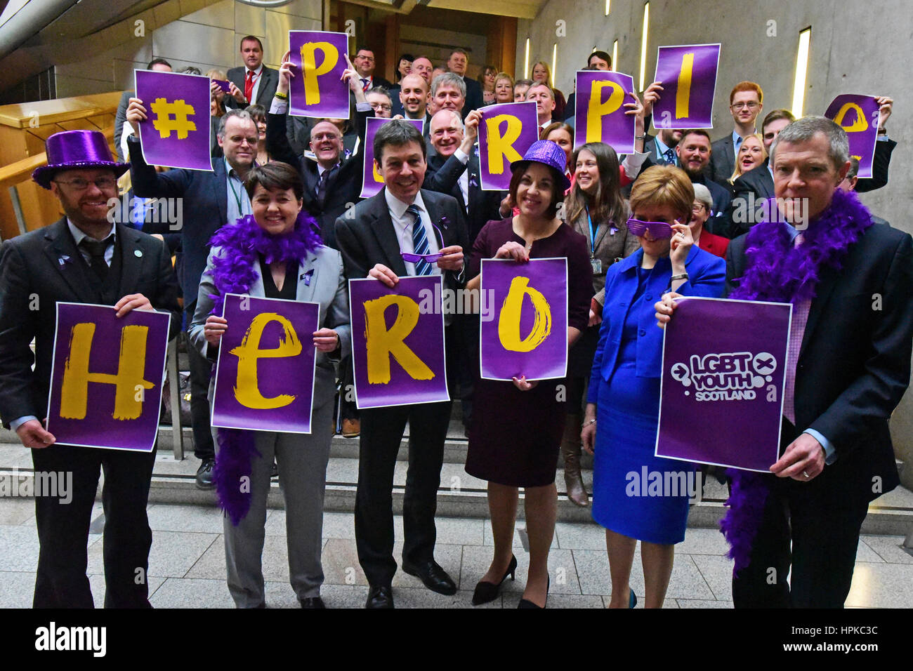 Edinburgh, Scotland, UK. 23rd Feb, 2017. First Minister Nicola Sturgeon wears purple spectacles as she joins Scottish Ministers, other party leaders, and MSPs at a photocall in the Scottish Parliament to show support for LGBTI youth ahead of "#Purple Day" Front Row L to R: Patrick Harvie, Ruth Davidson, Presiding Officer Ken Macintosh, Kezia Dugdale, Nicola Sturgeon, Willie Rennie Credit: Ken Jack/Alamy Live News Stock Photo