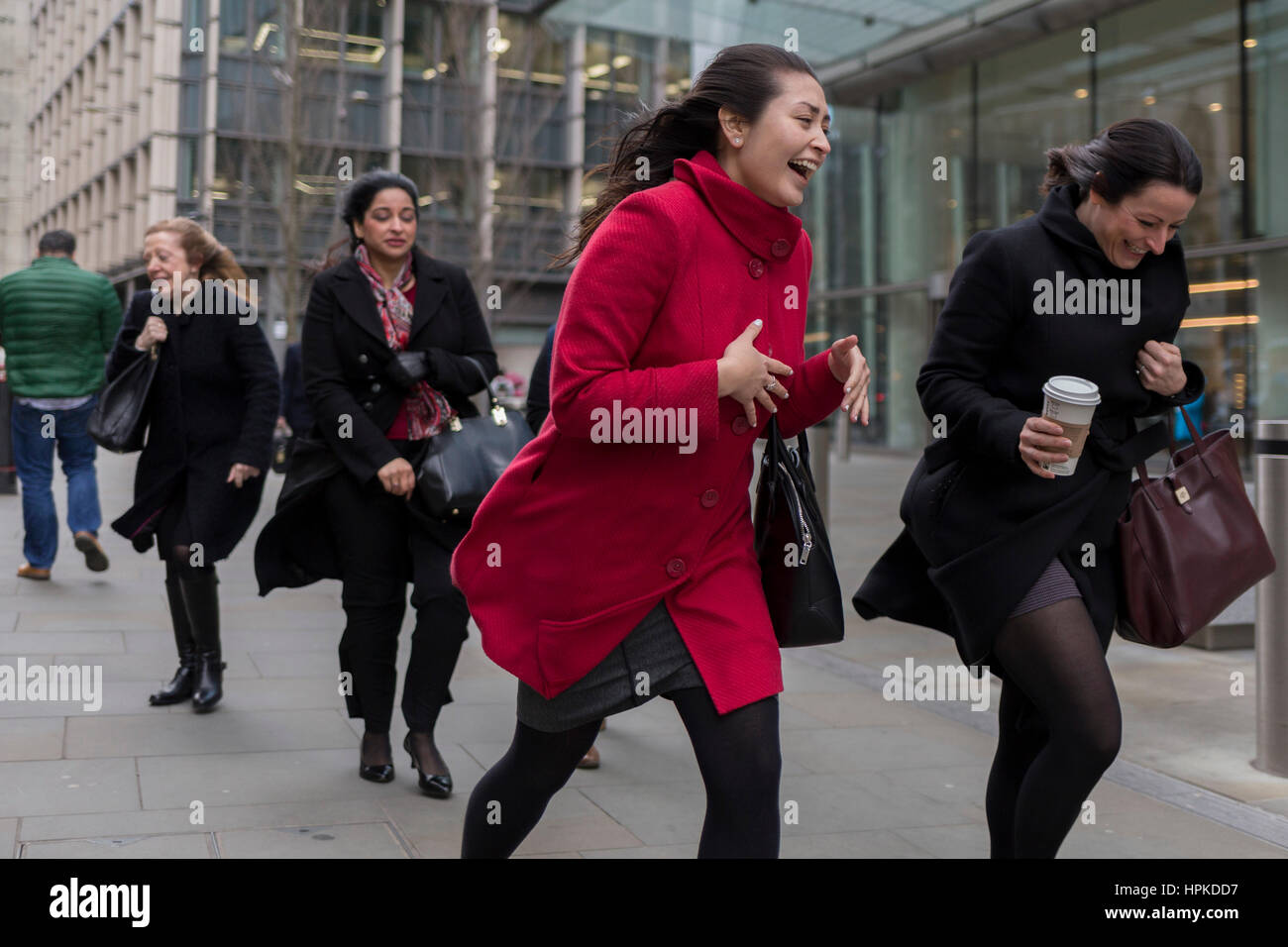 London, UK. 23rd Feb, 2017. London, UK. 23rd February 2017. As Storm Doris blows across the UK, pedestrians on Fenchurch Street, brave the high winds funneled through the narrow streets, squeezed between the tall buildings of financial and insurance institutions in the City of London, on 23rd February 2017. Strong winds have led to flight cancellations and road and rail disruption across much of Britain. Thousands of homes have been left without power in Northern Ireland, Wales, Scotland and northern England. Credit: Richard Baker/Alamy Live News Stock Photo