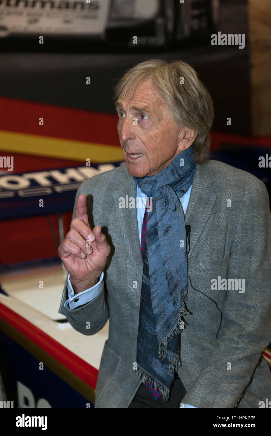 Dereck Bell, at a photo call on the Ickx display stand during the 2017 London Classic Car Show. Stock Photo