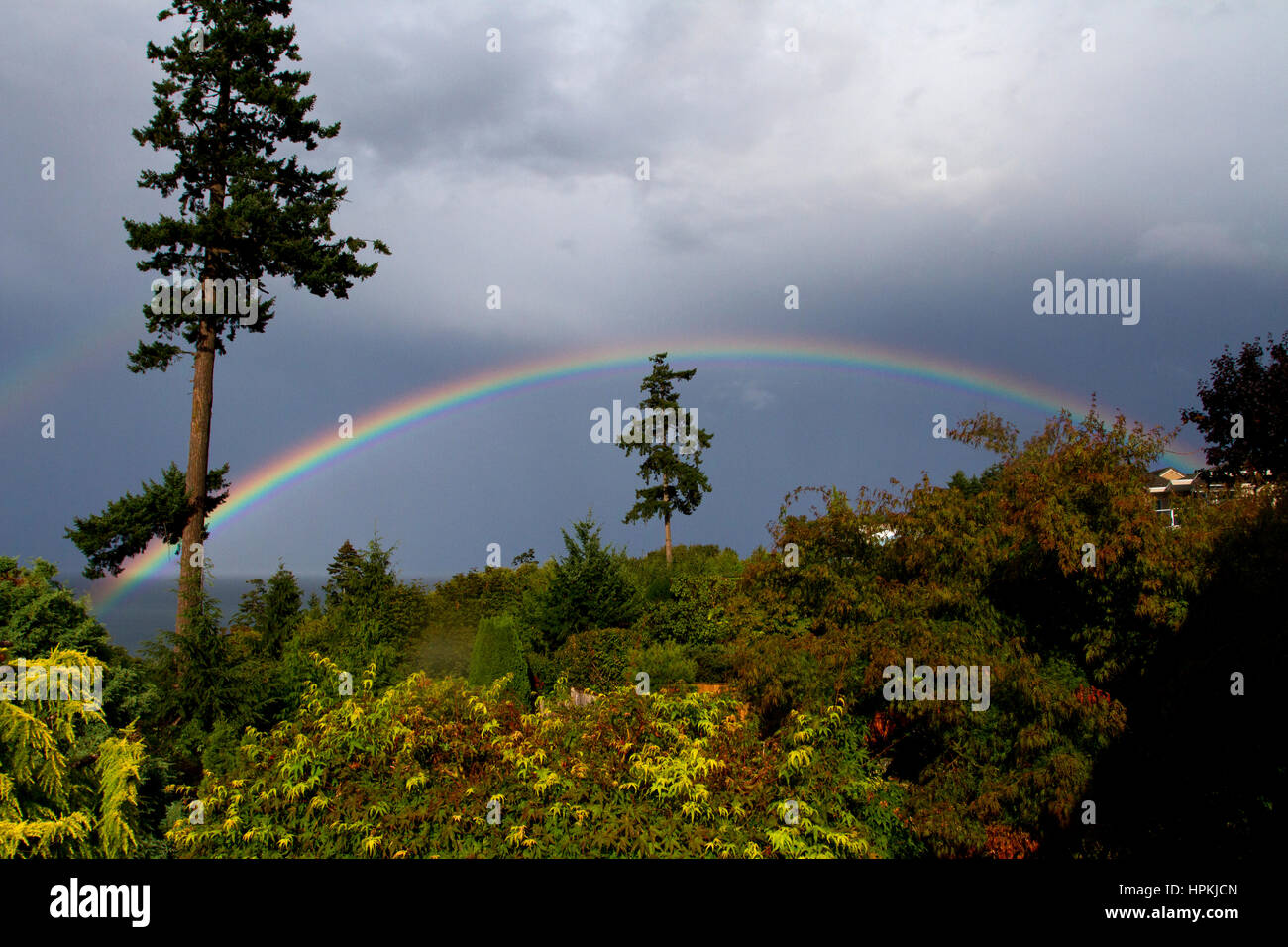 Rainbow over the Strait of Georgia from north Nanaimo, BC, Canada Stock Photo