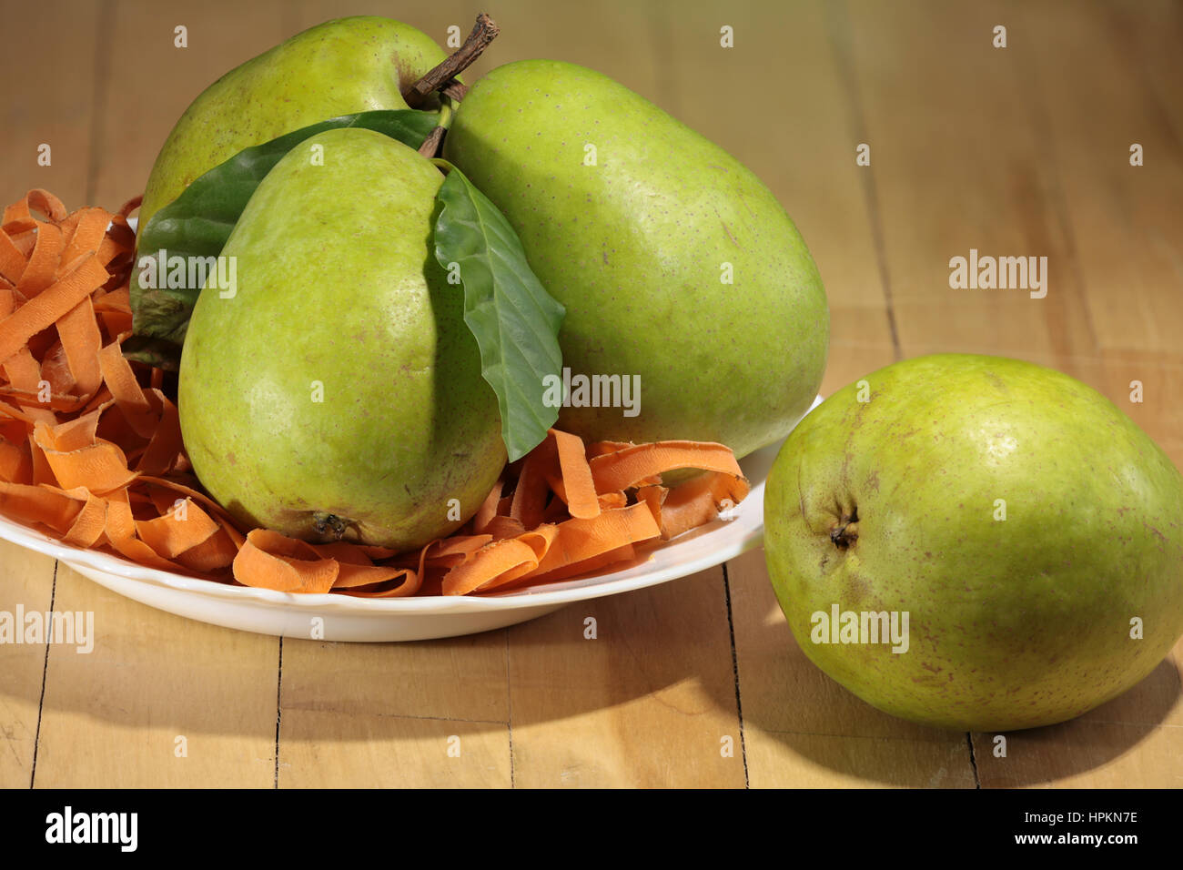 large ripe pears in the plate on the table Stock Photo