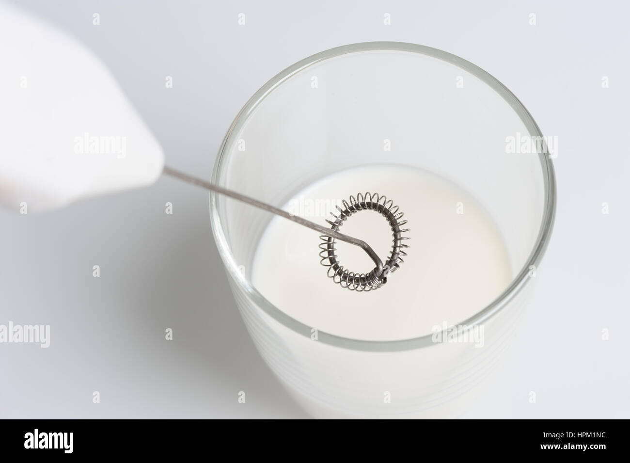 closeup milk frother and half cup of milk Stock Photo Alamy