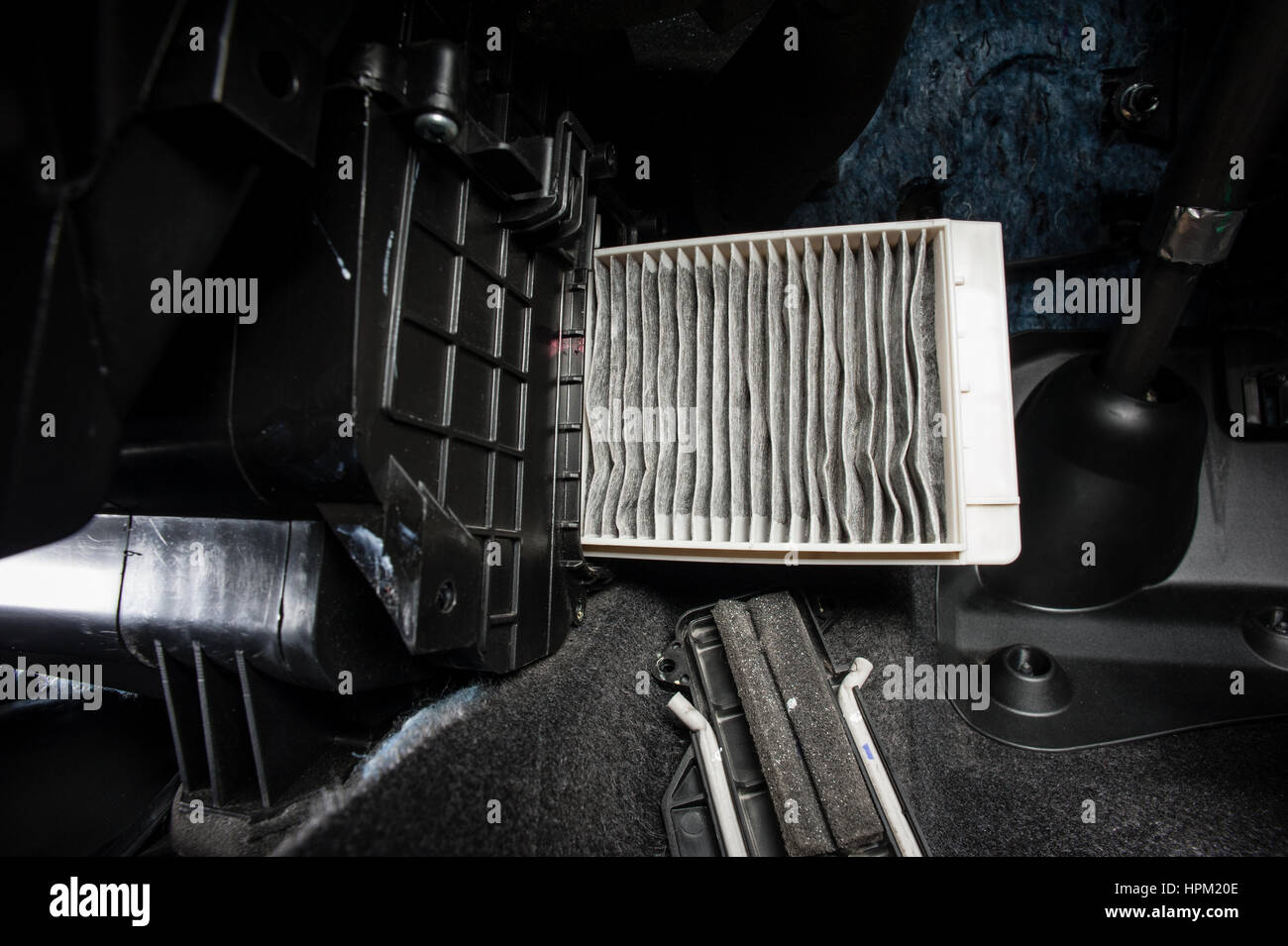 Replacing an old car cabin pollen filter Stock Photo - Alamy