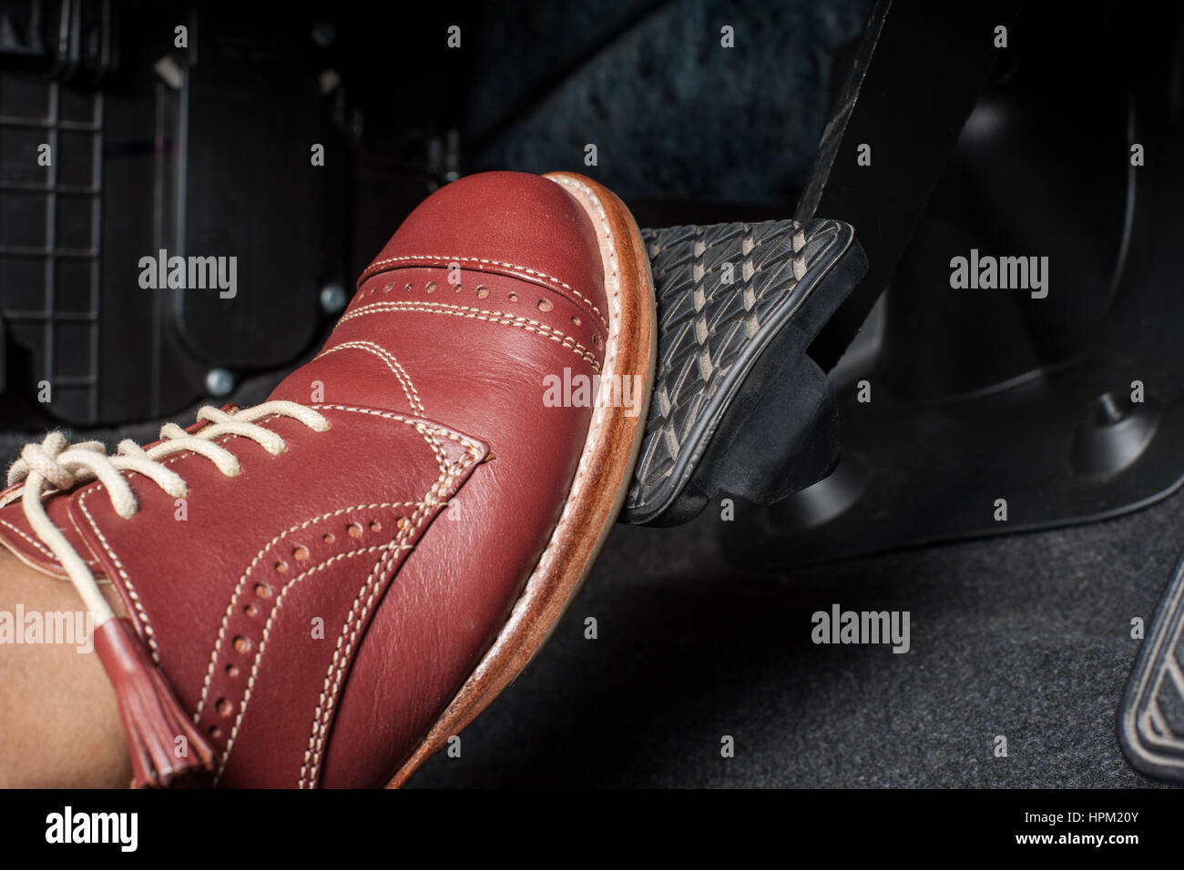 foot pressing the brake pedal of a car Stock Photo - Alamy
