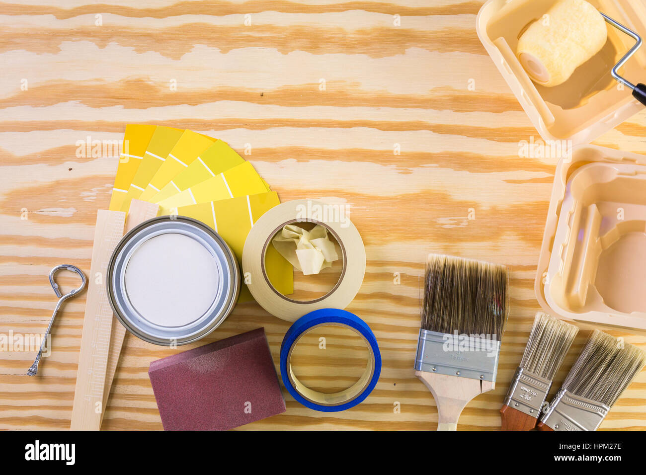 Paint in metal paint can and painters tools on a wood board Stock Photo