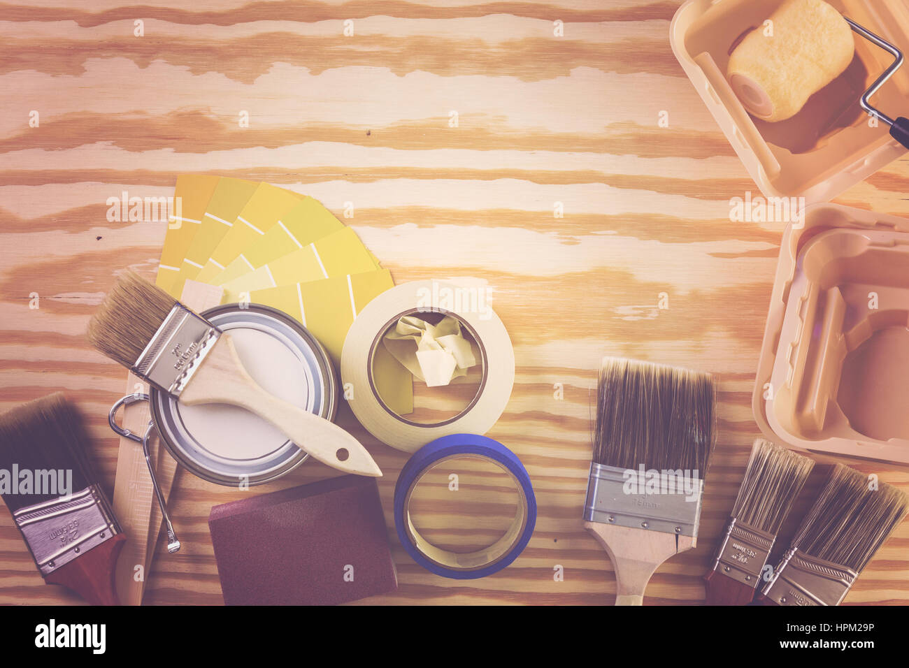 Paint in metal paint can and painters tools on a wood board Stock Photo