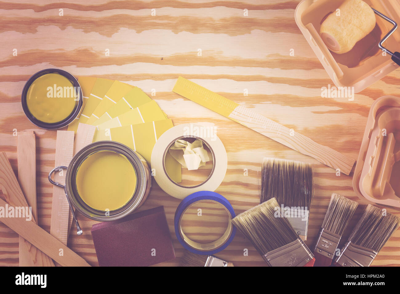 Paint in metal paint can and painters tools on a wood board Stock Photo