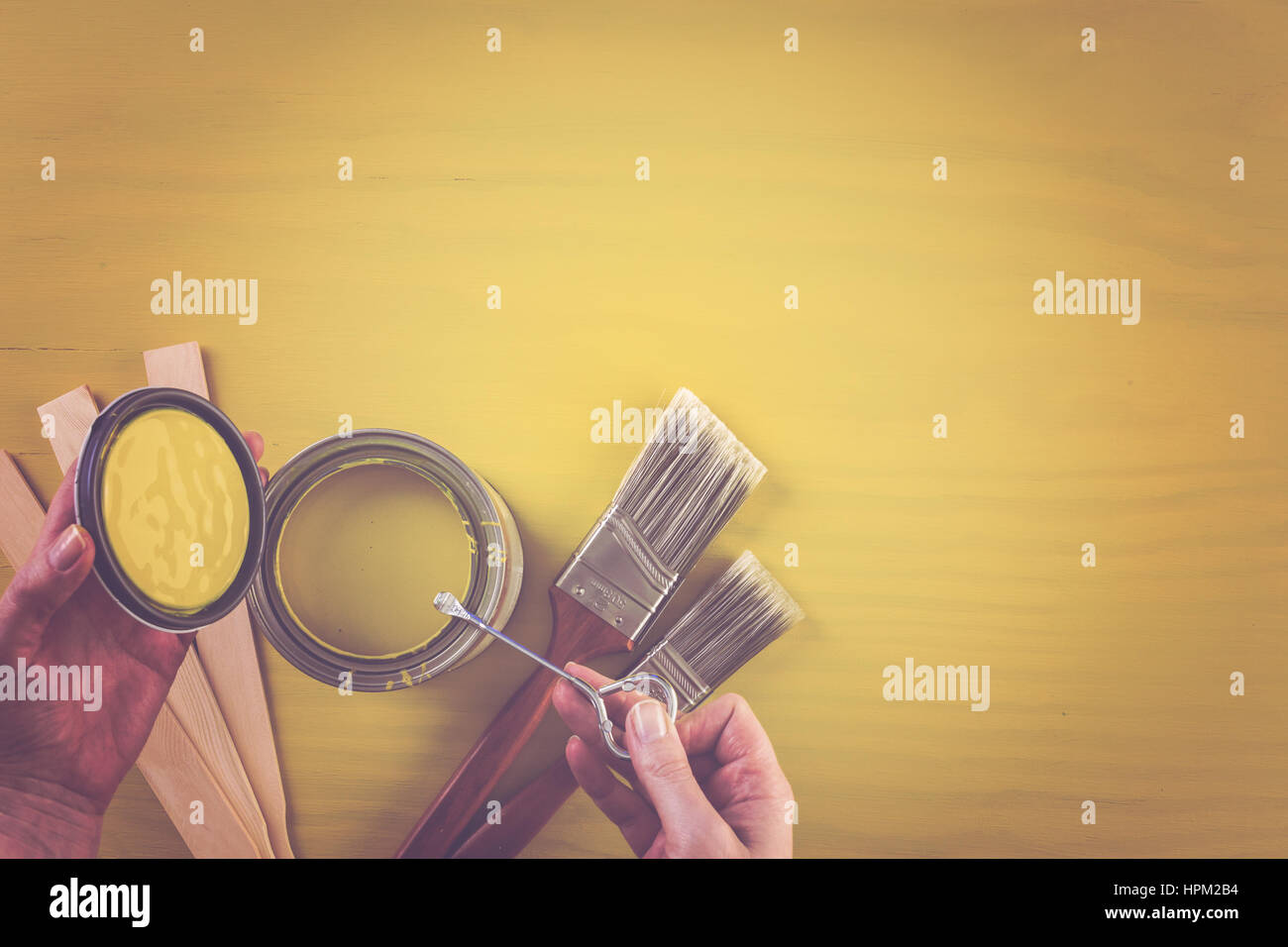Paint in metal paint can and painters tools on a wood board Stock Photo