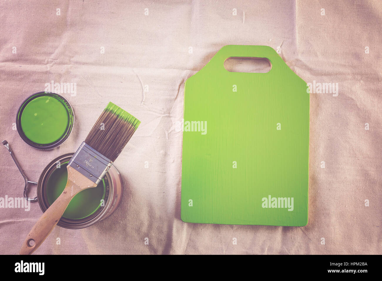 Paint in metal paint can and painters tools on a canvas drop cloth