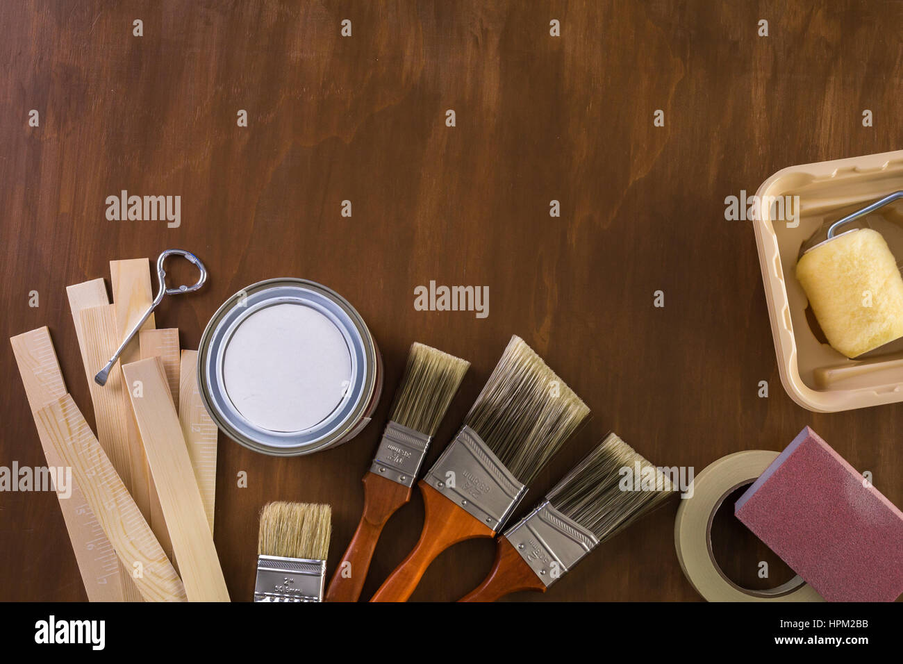 Paint in metal paint can and painters tools on a wood board Stock Photo