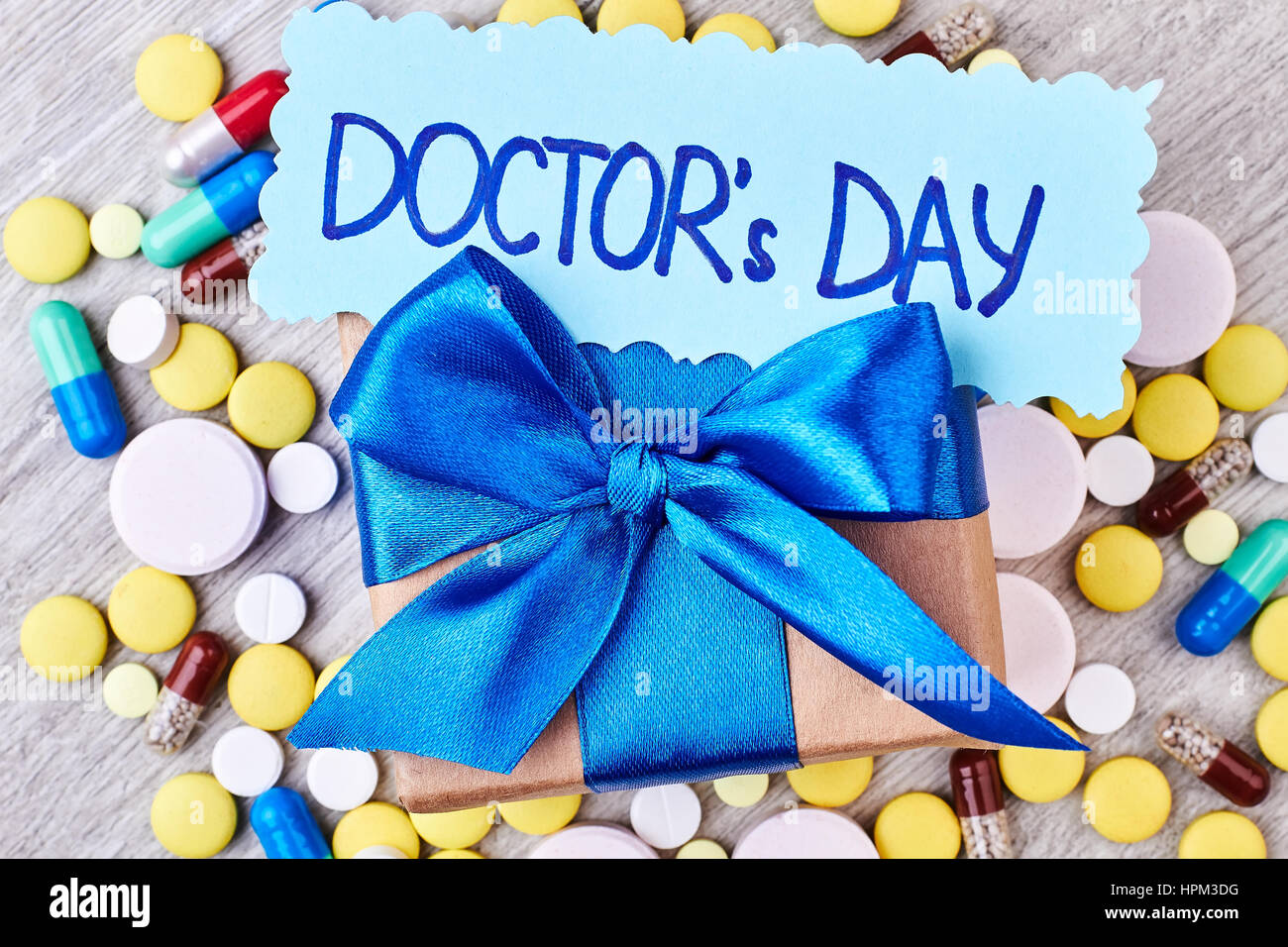 Pills, capsules, box with bow. Stock Photo