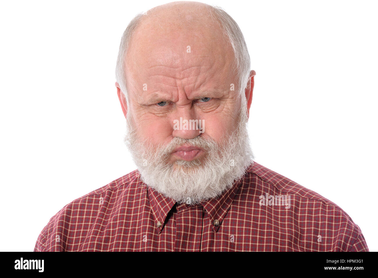 Handsome bald and bearded senior man shows resentful facial expression ...