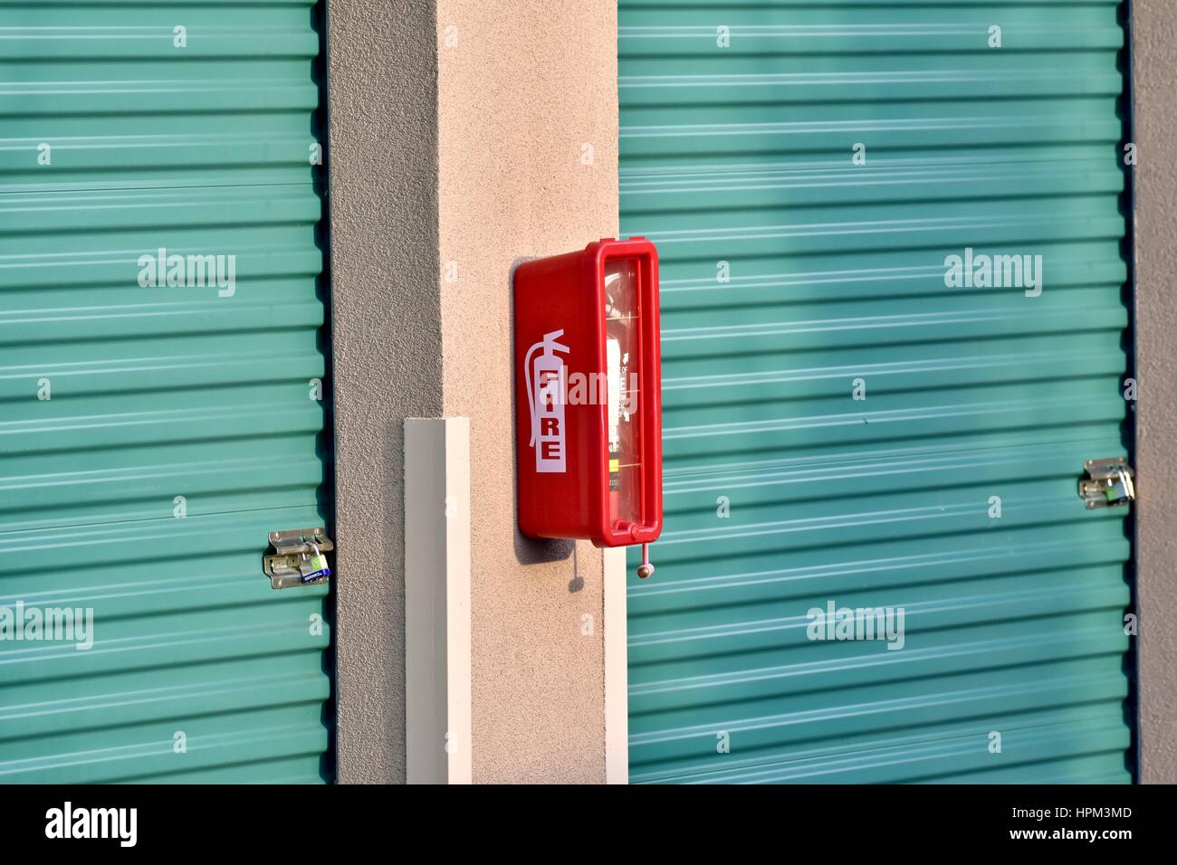 Fire extinguisher hanging from wall Stock Photo Alamy